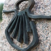 Milestone with a shell, the symbol of Santiago way. Spain